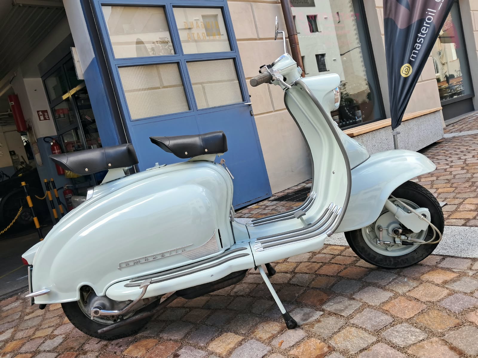 Klassisches Moped vor dem Werkstatteingang in Latsch